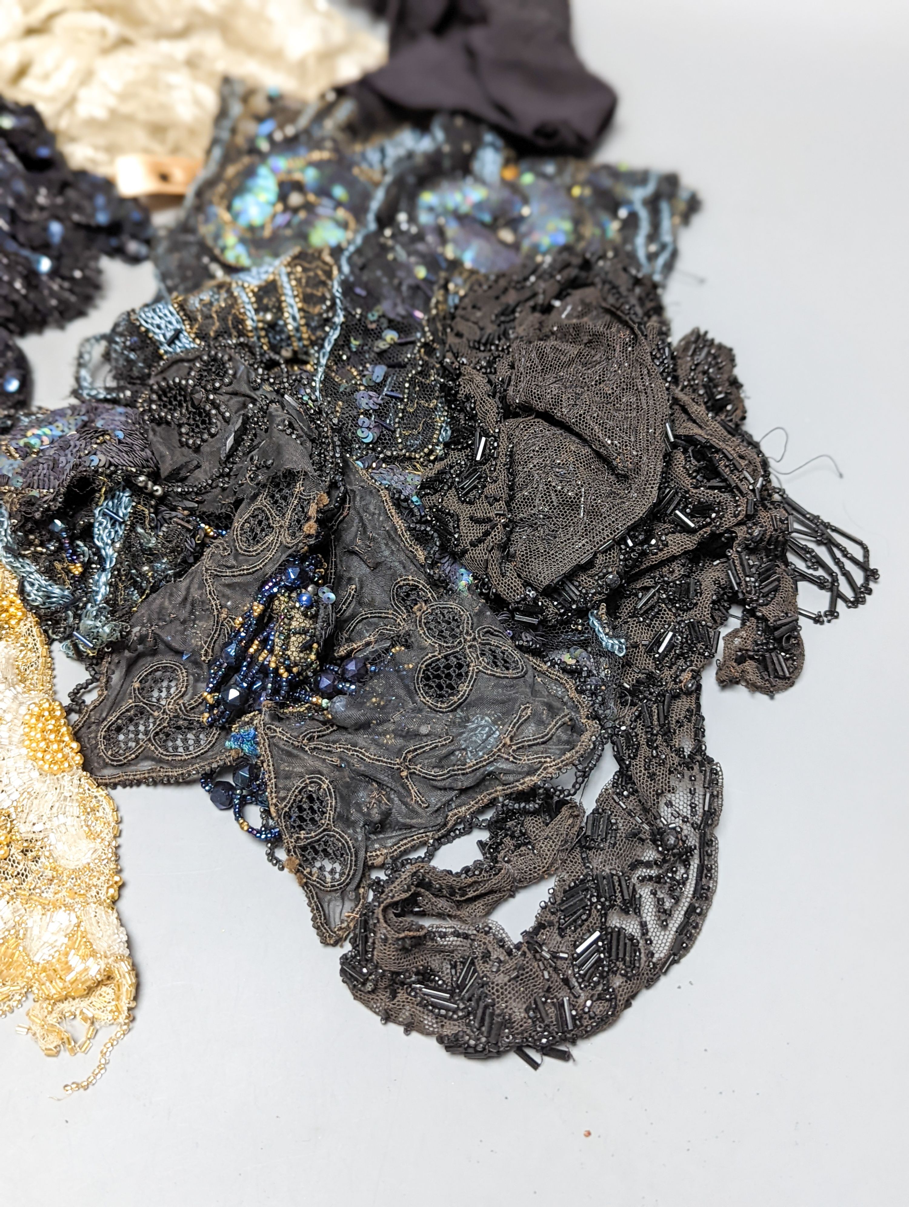A collection of Edwardian and later sequin and beaded panels on net, a black beaded stole, various buttons etc.